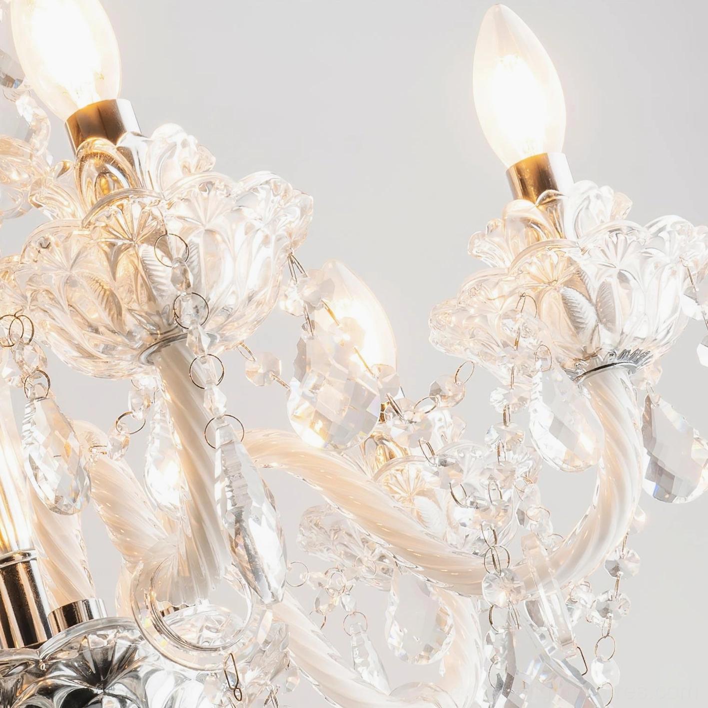 Detailed view of giraffe floor lamp with crystal candle elements and illuminated chandelier creating ambient light effects