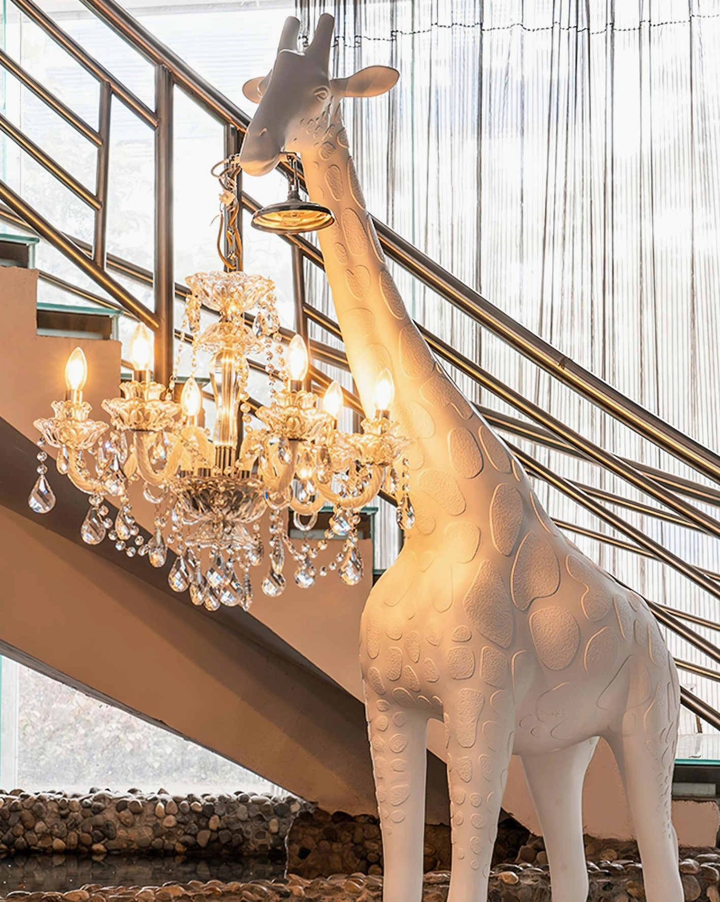 Full-length front view giraffe floor lamp with contemporary sculptural design and illuminated crystal pendant