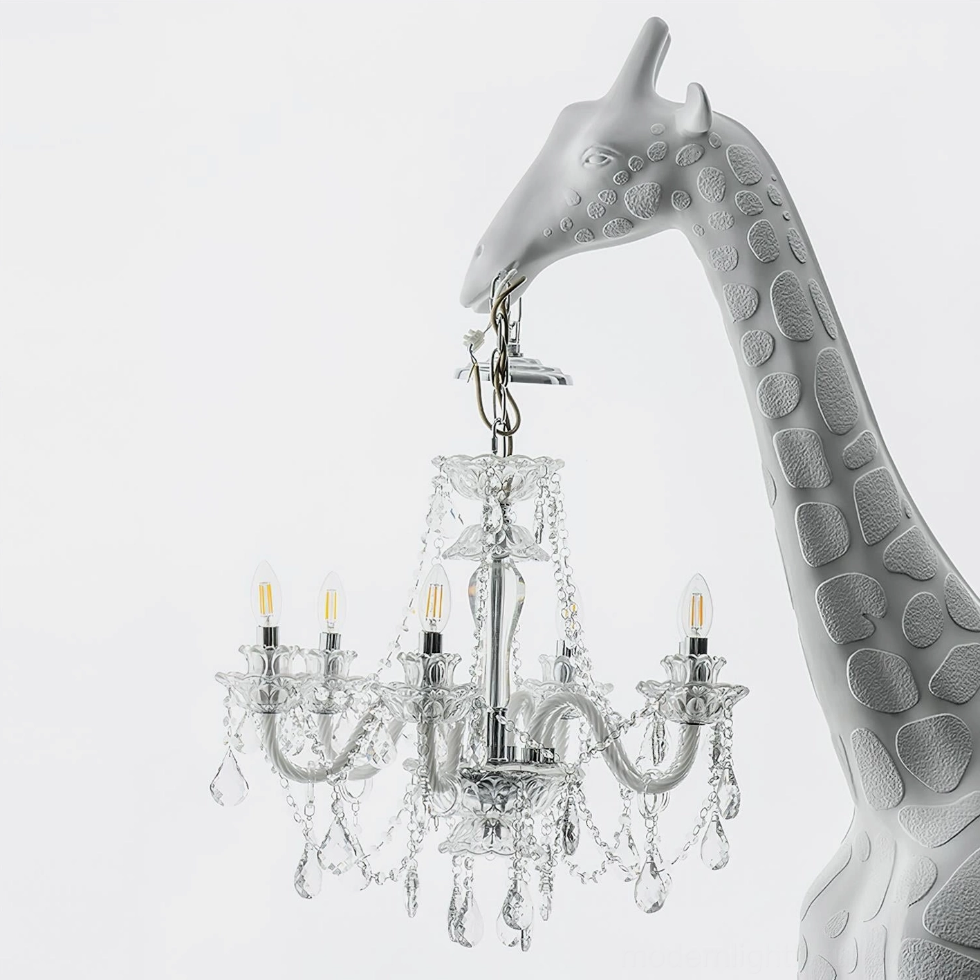 Giraffe floor lamp side profile close-up showing detailed resin body texture and suspended crystal chandelier lighting