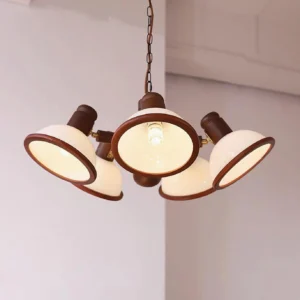 Industrial-style 5-head chandelier with white glass bowl shades in warm residential living room setting