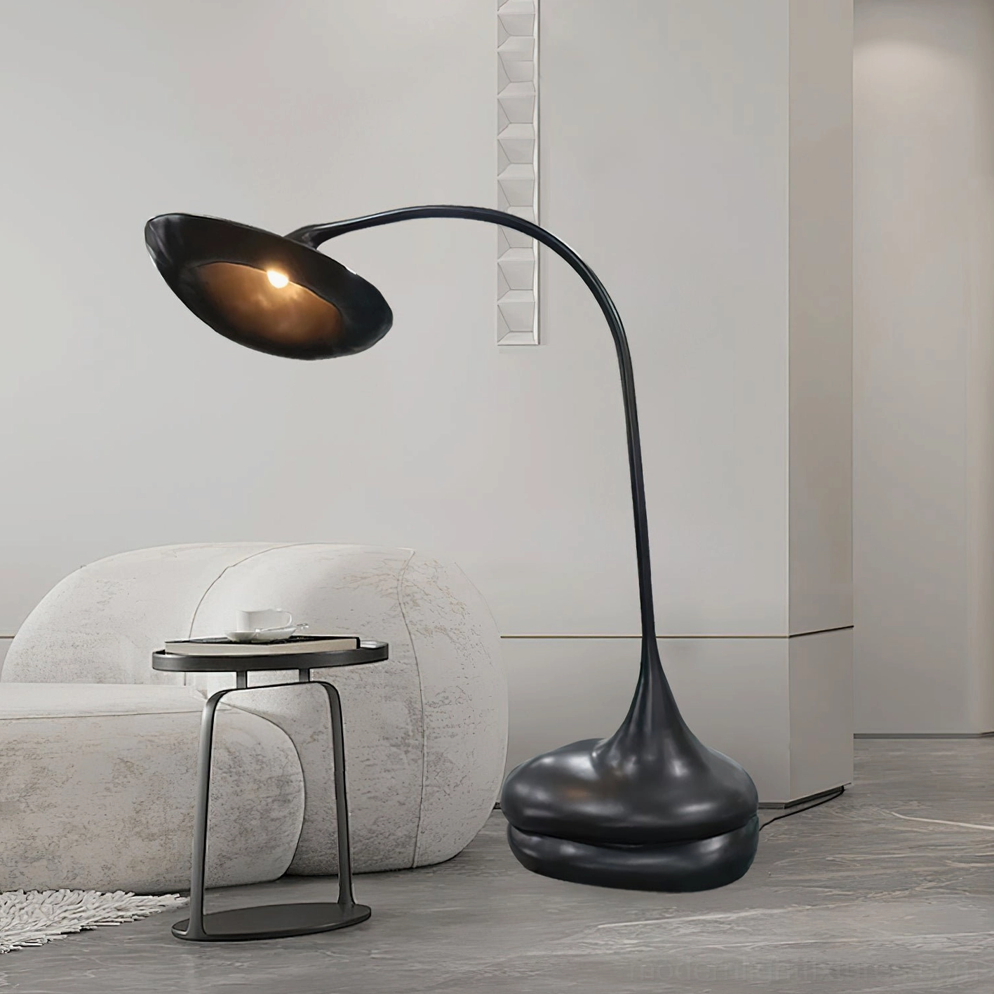 Modern black floor lamp in contemporary minimalist living room with curved sofa and side table