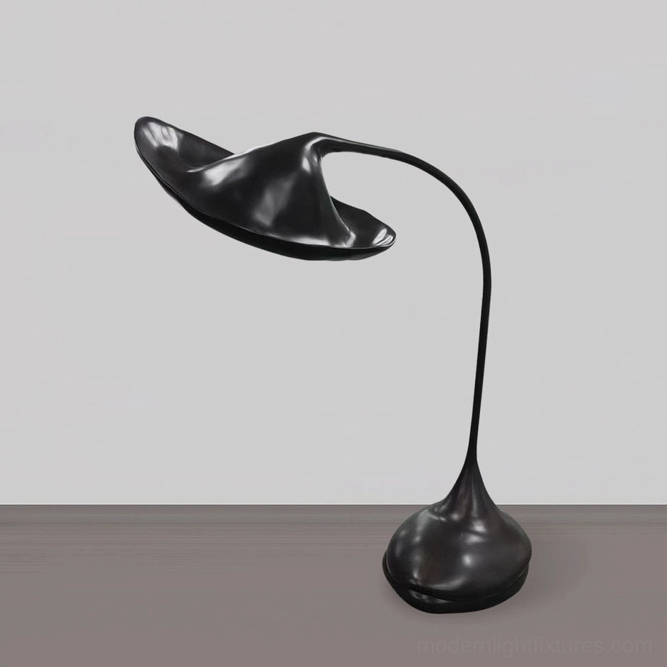 Side profile of asymmetrical black floor lamp base showing fluid organic curves and elegant silhouette