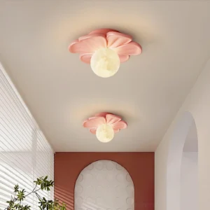 Two pink Giulia flower ceiling light fixtures installed in residential corridor with warm ambient lighting and arched decorative wall