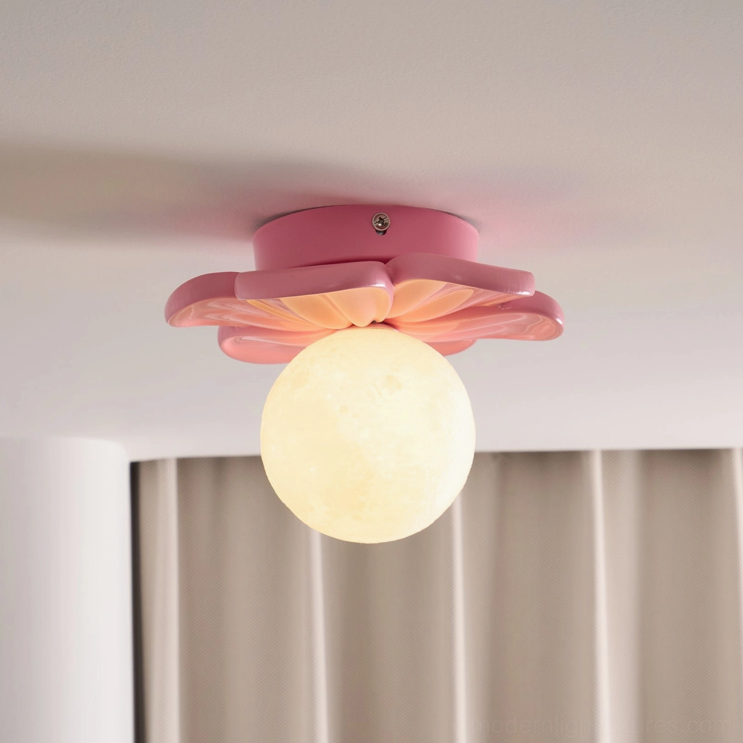 Giulia pink flower ceiling light creating warm ambient mood lighting in residential space