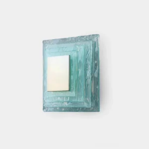 Glacira frosted glass wall sconce front view on white wall, modern layered aqua glass design with warm LED glow