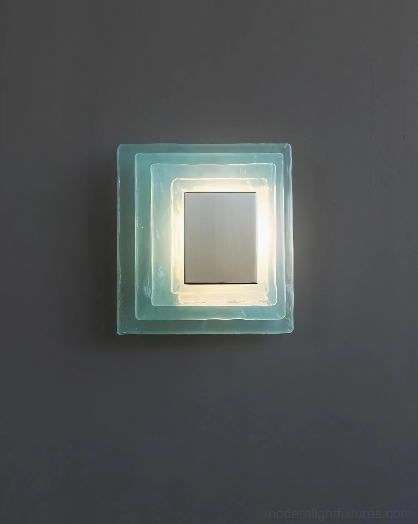 Glacira wall sconce illuminated detail shot on dark wall, layered frosted glass with warm LED backlight and shadow play