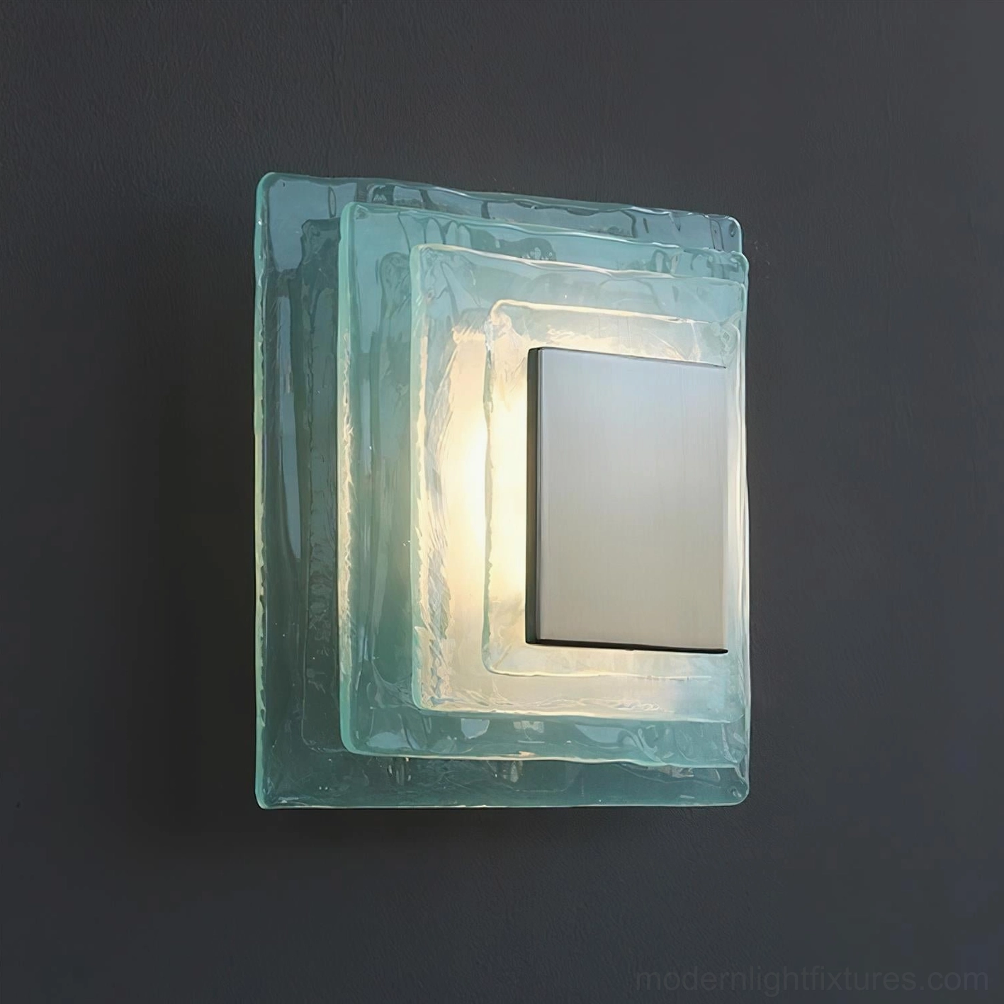 Illuminated Glacira wall sconce on dark wall showing warm white LED glow from frosted glass layers, ambient lighting effect