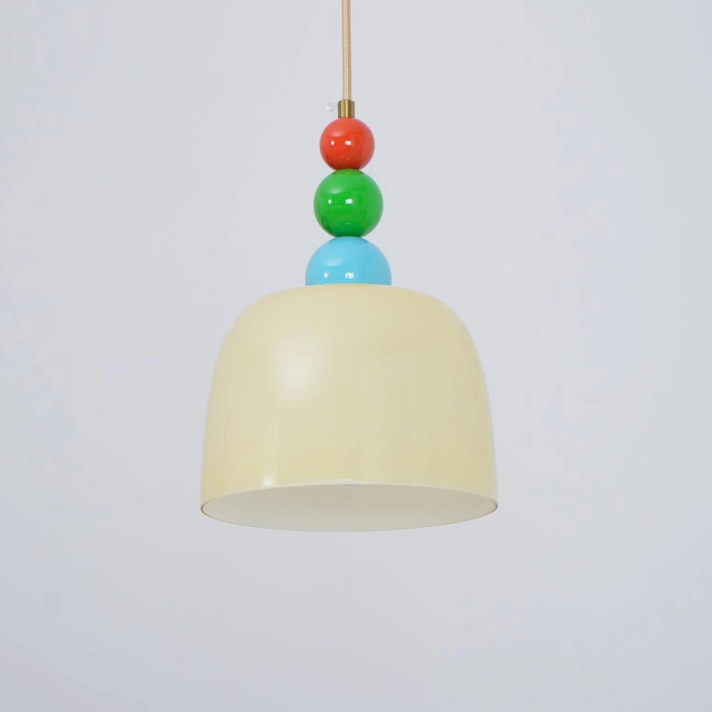 Stacked glass bead pendant light design combining artisanal craftsmanship with modern style
