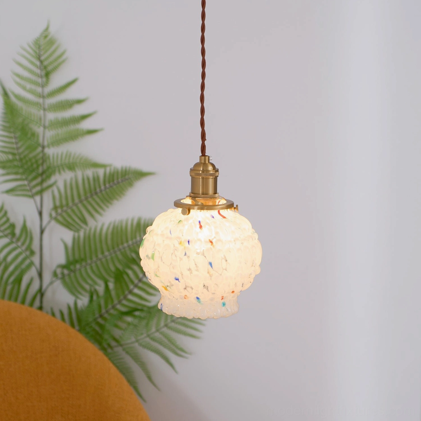 Hand-blown glass bubble pendant light installation example, warm ambient interior lighting, contemporary home design aesthetic