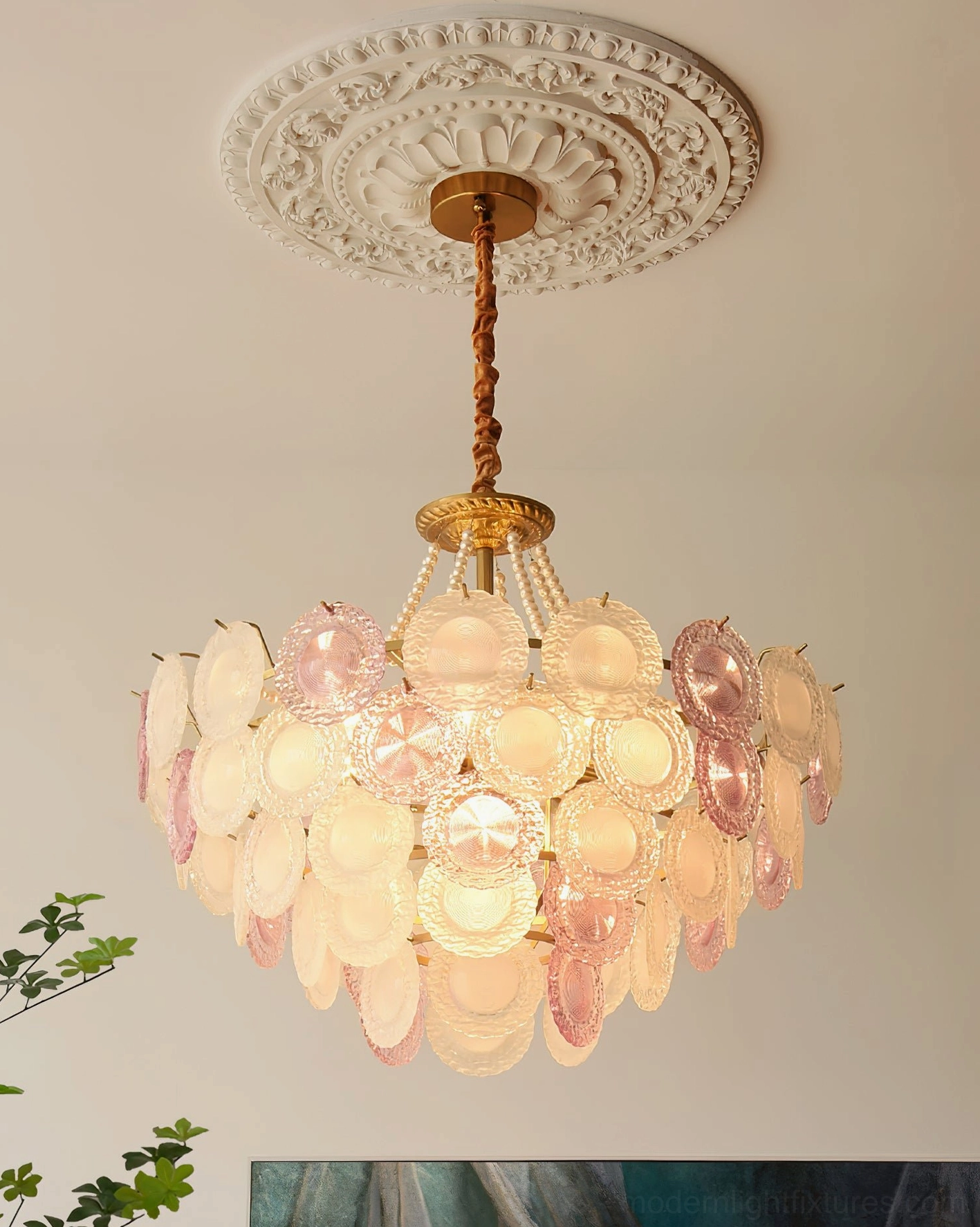 Violaire glass chandelier upward view from below showing illuminated pink glass shades and brass suspension hardware