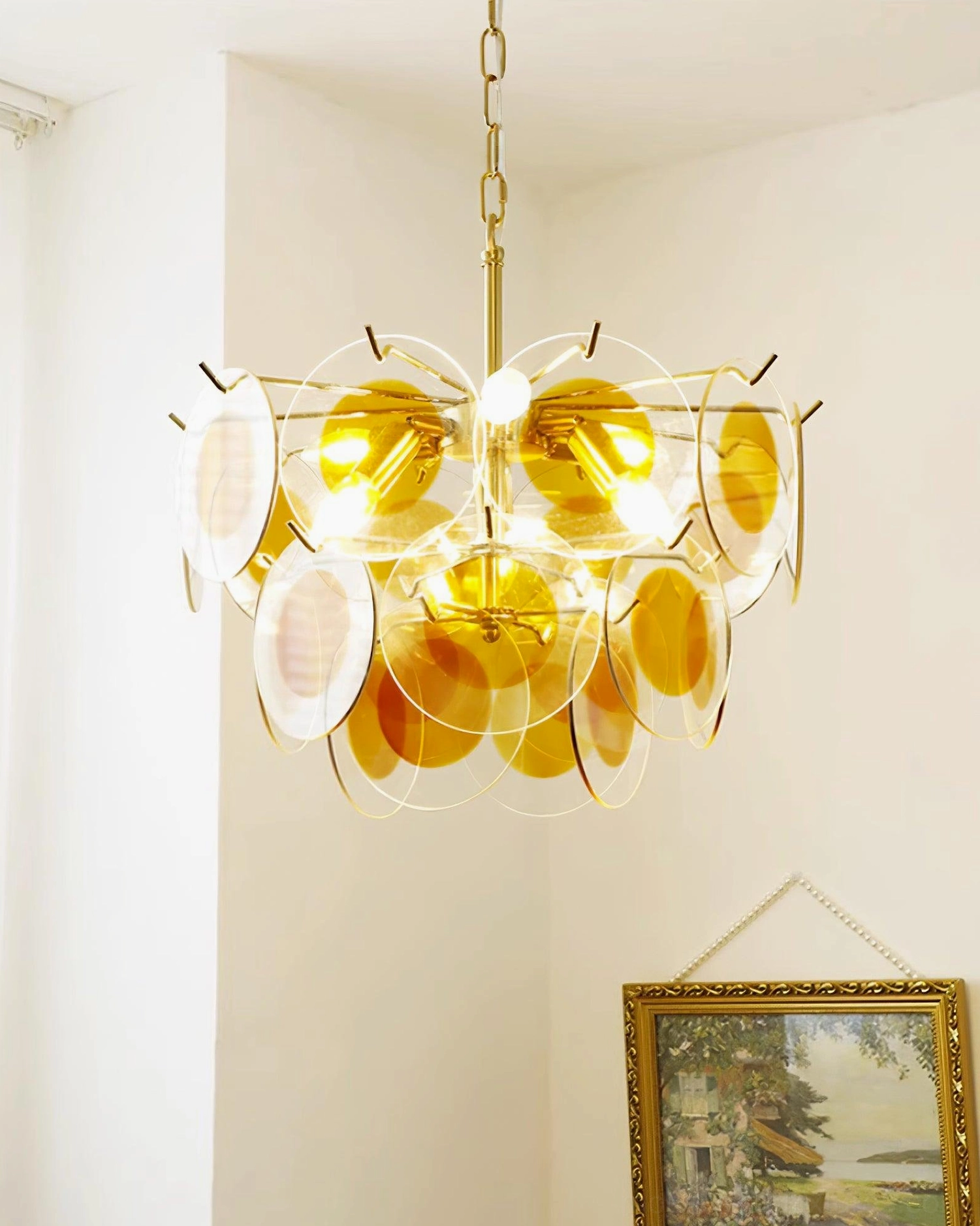 Modern glass disc chandelier ambient lighting warm glow interior residential luxury home decor