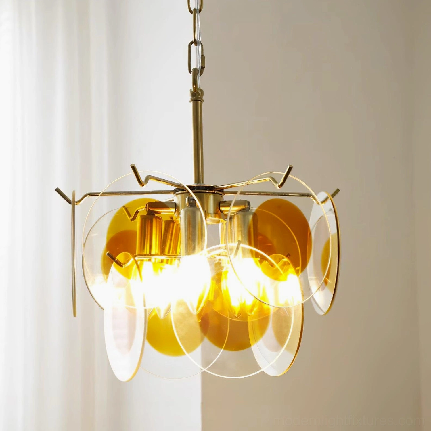 Modern glass disc pendant chandelier architectural detail design shadow light play elegance