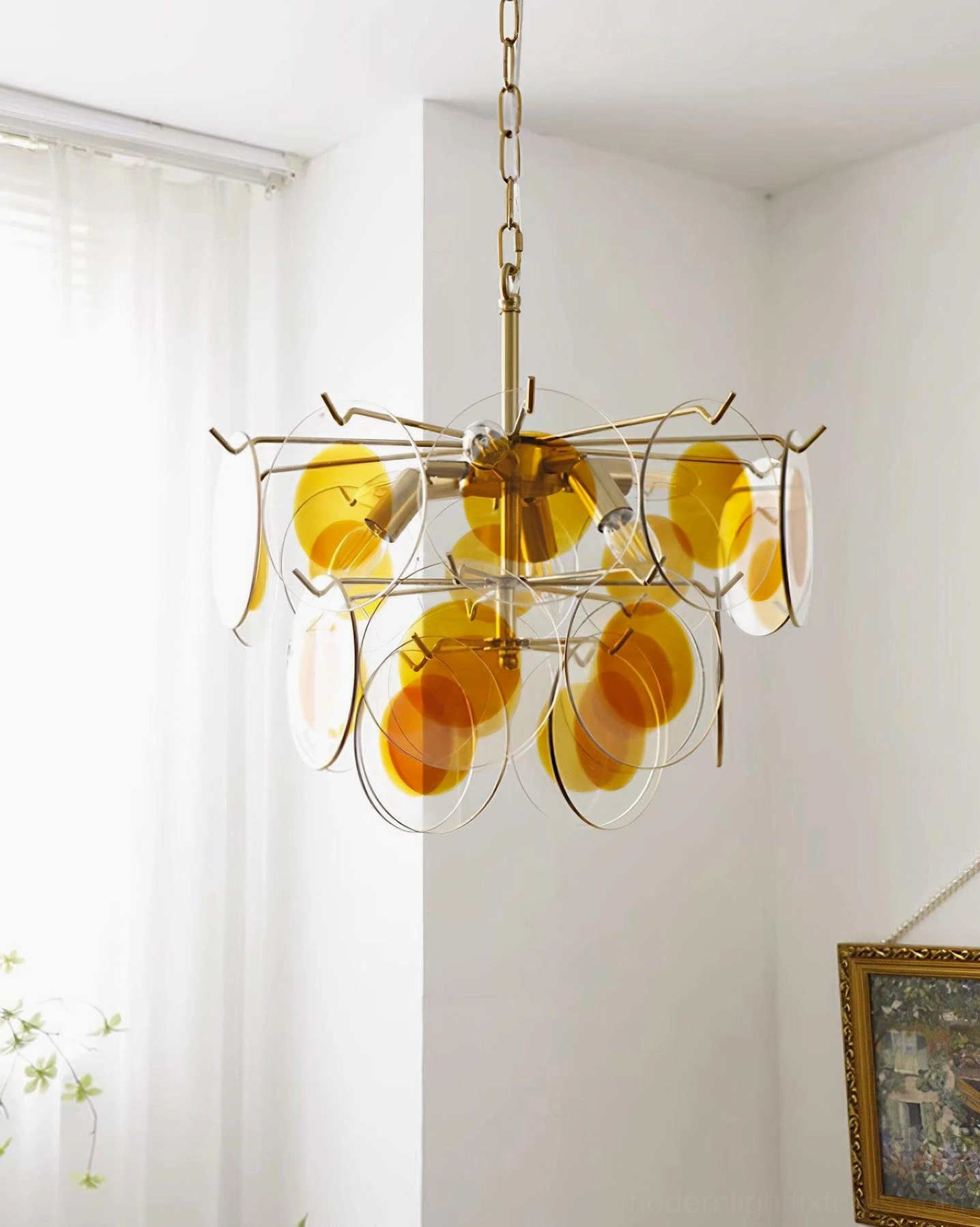 Contemporary glass disc chandelier dual tone shades sunlit residential corner artistic wall decor side view