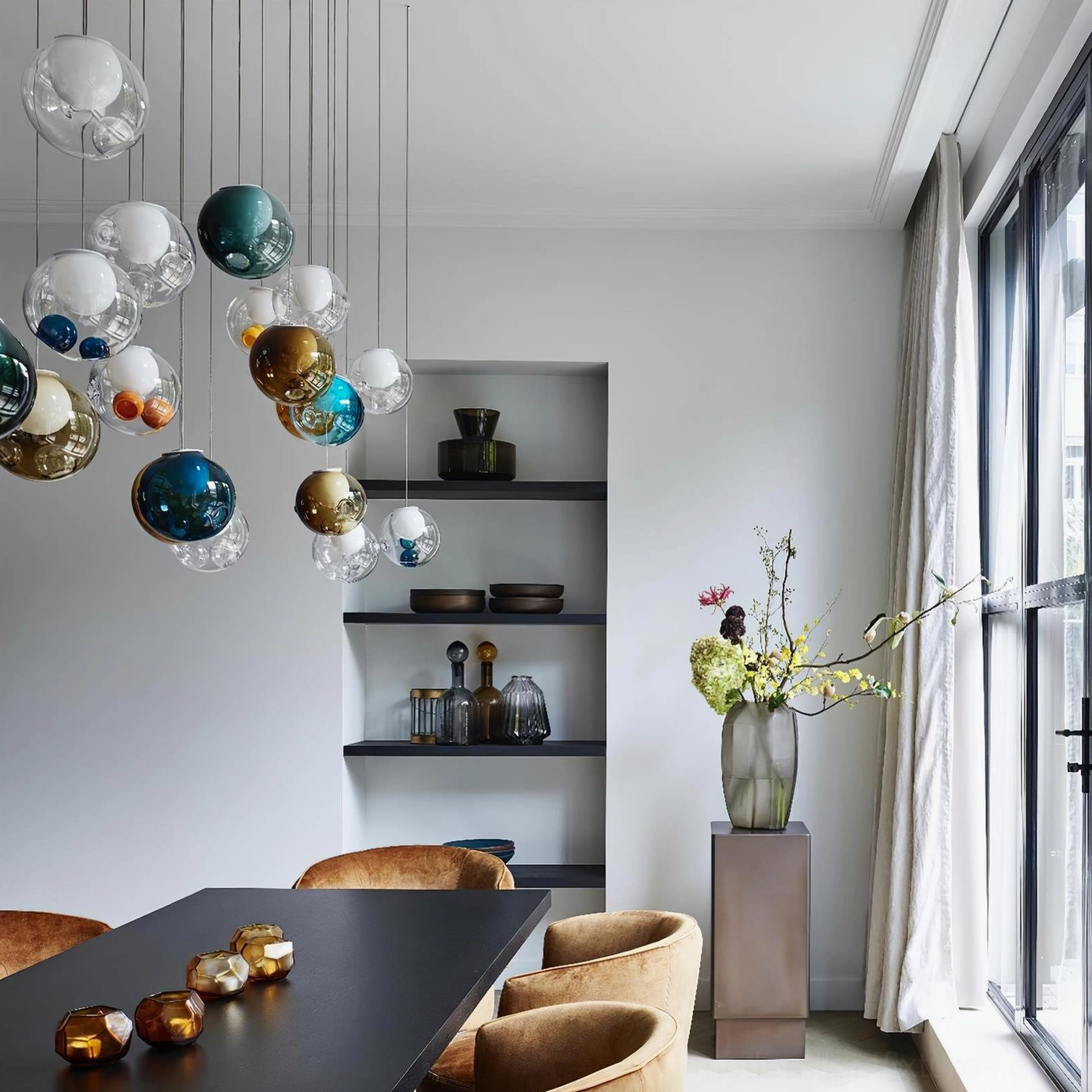 Glass globe cluster chandelier installation showing chrome canopy and adjustable cable system in contemporary home