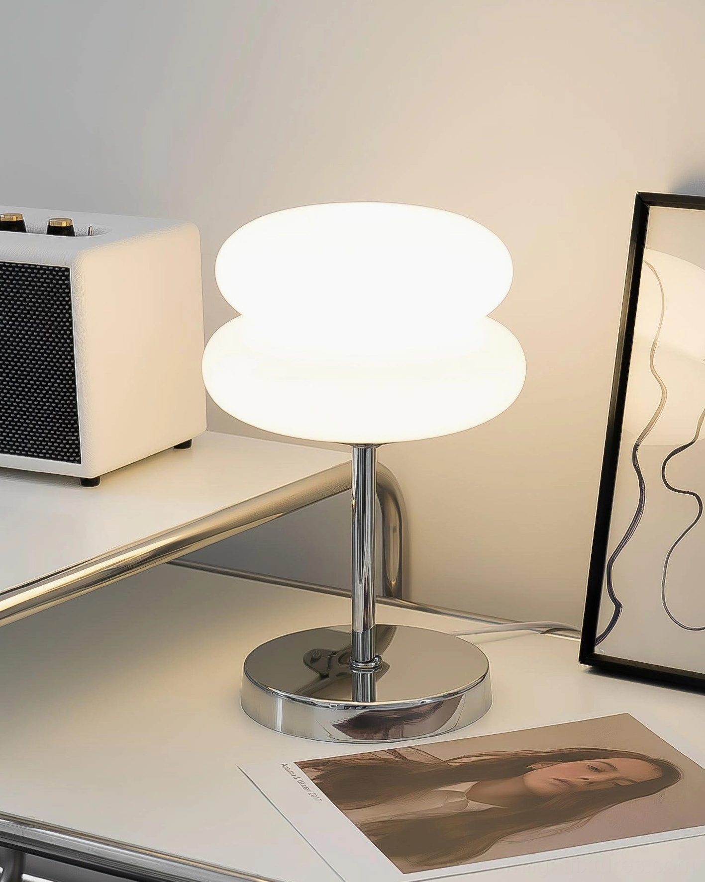 White glass shade table lamp creating soft ambient lighting in modern interior space