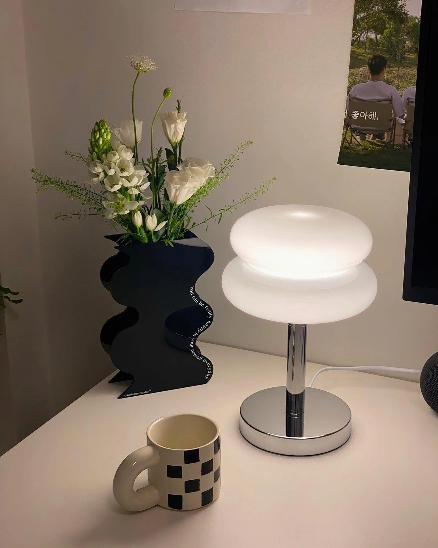 Modern glass table lamp providing task lighting for home office and reading spaces