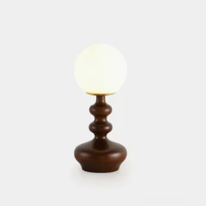 Gleason mid-century modern globe table lamp with dark brown turned wood base and frosted glass shade on studio background