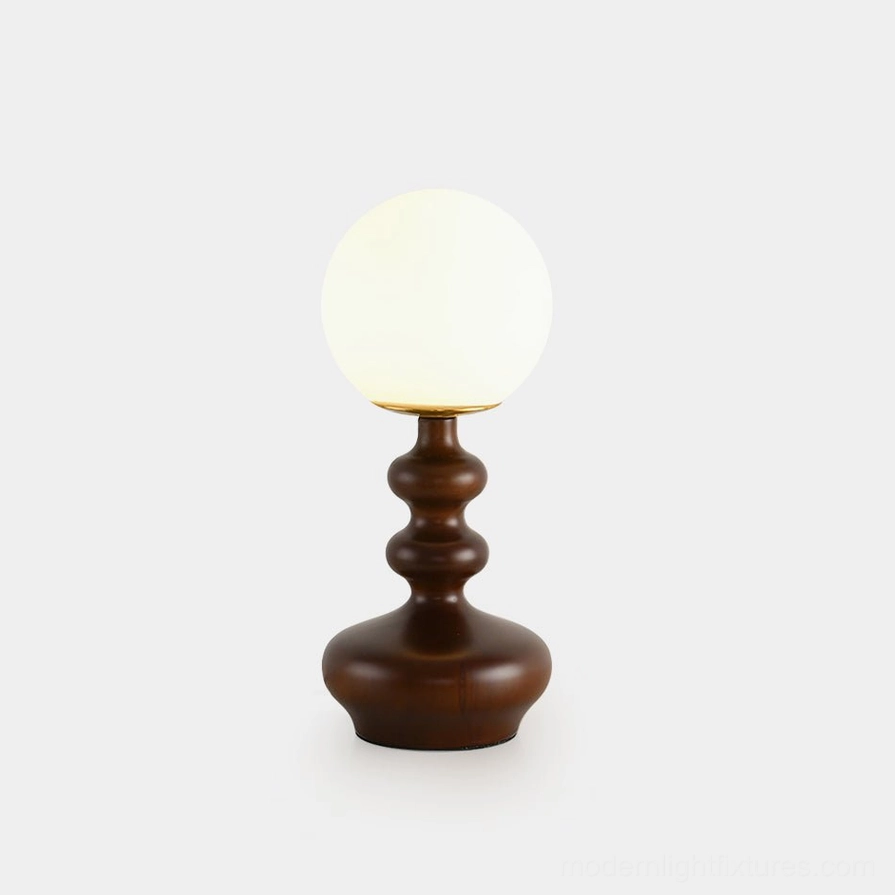 Gleason mid-century modern globe table lamp with dark brown turned wood base and frosted glass shade on studio background