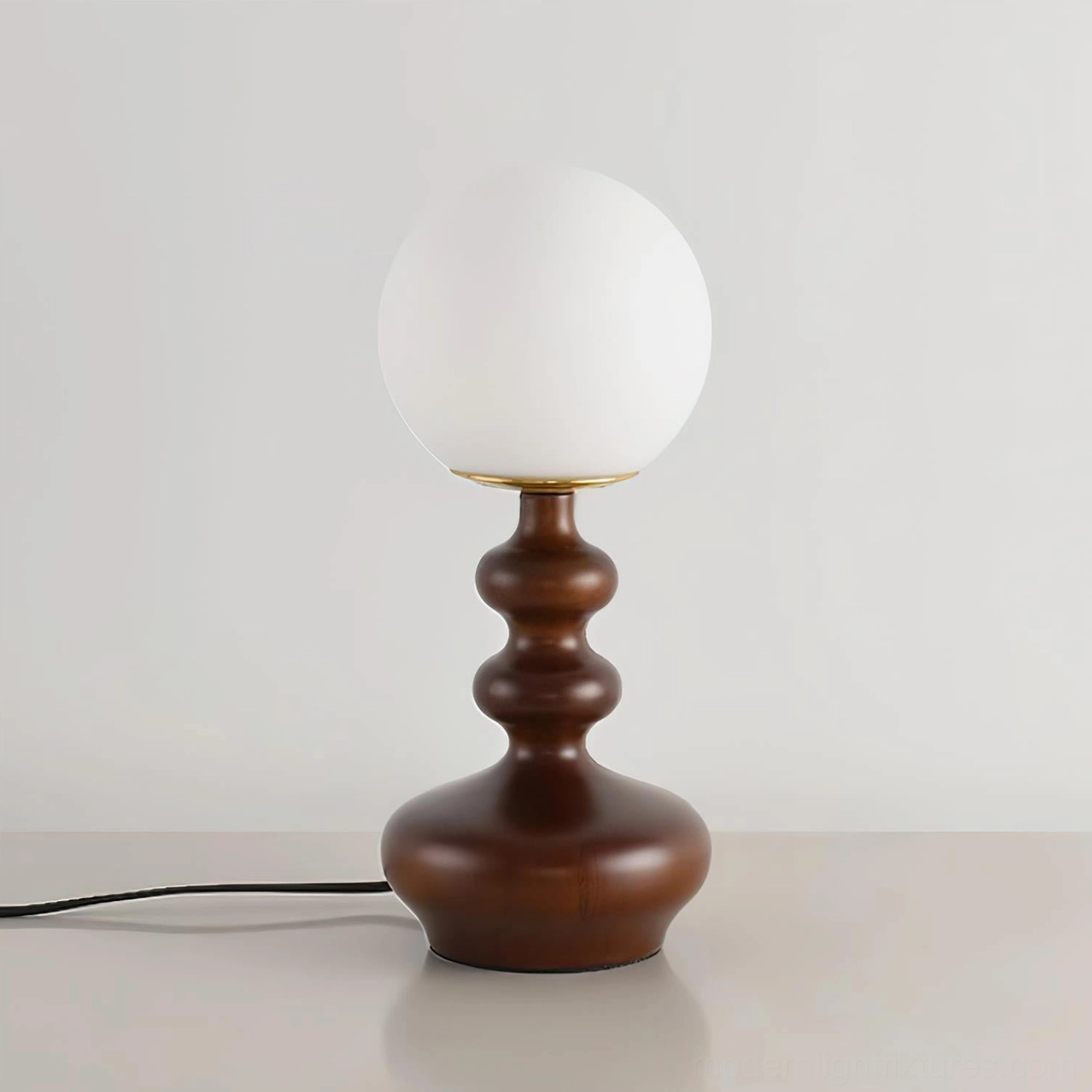 Gleason mid-century table lamp with dark brown turned wood base and frosted unlit white glass shade on tabletop