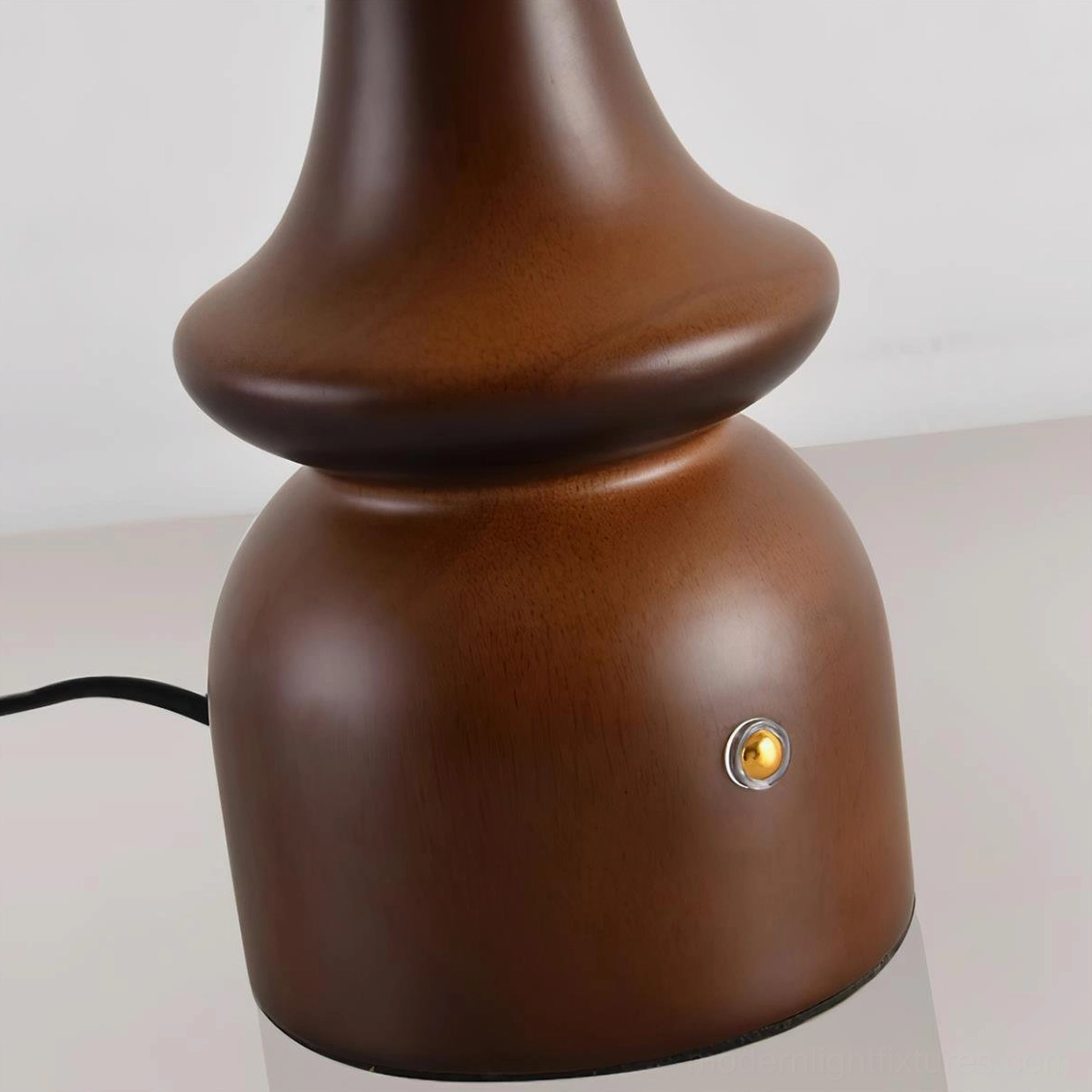 Gleason modern table lamp with wood base and frosted glass shade in warm home lighting scene