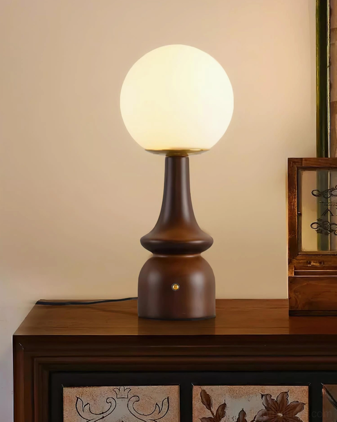 Gleason modern table lamp with warm wood finish displaying soft diffused light from frosted sphere