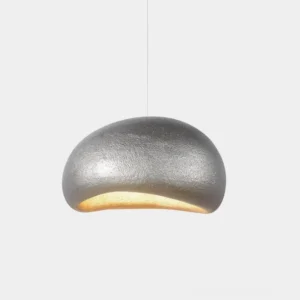 Textured dome pendant light with silver matte finish, close-up studio view showing organic pebble surface detail and warm bottom illumination