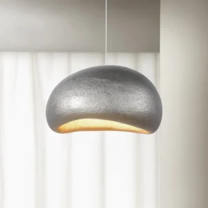 Modern textured dome pendant lamp in silver finish, side profile indoor view with curtain backdrop and warm ambient downlighting