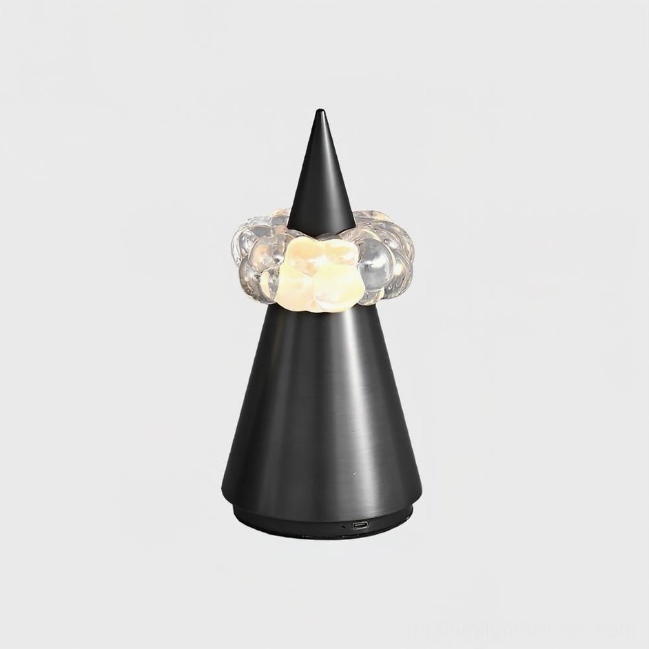 Matte black brushed metal sculptural table lamp with integrated LED crystal ring, modern minimalist design with USB charging port