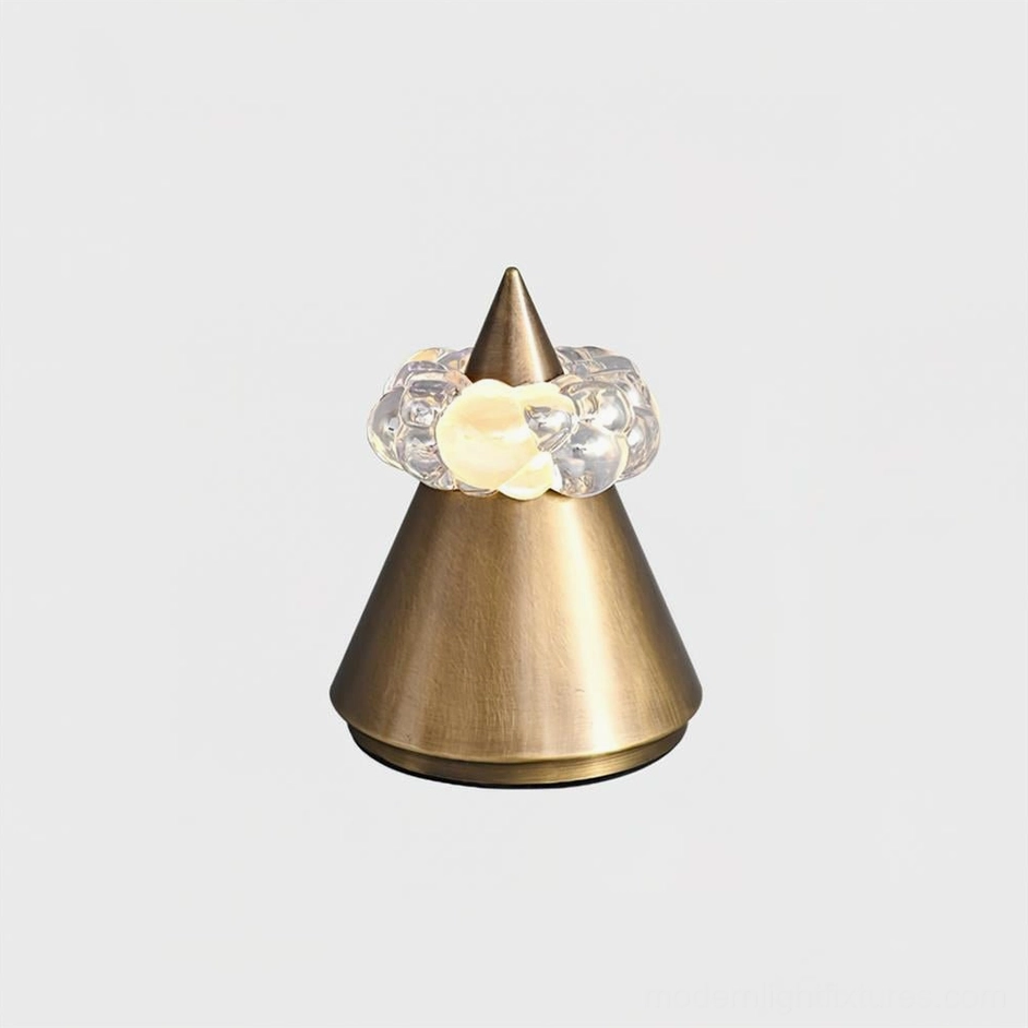 Brushed bronze Glint sculptural table lamp compact size on minimalist surface, warm ambient lighting from crystal orb diffuser