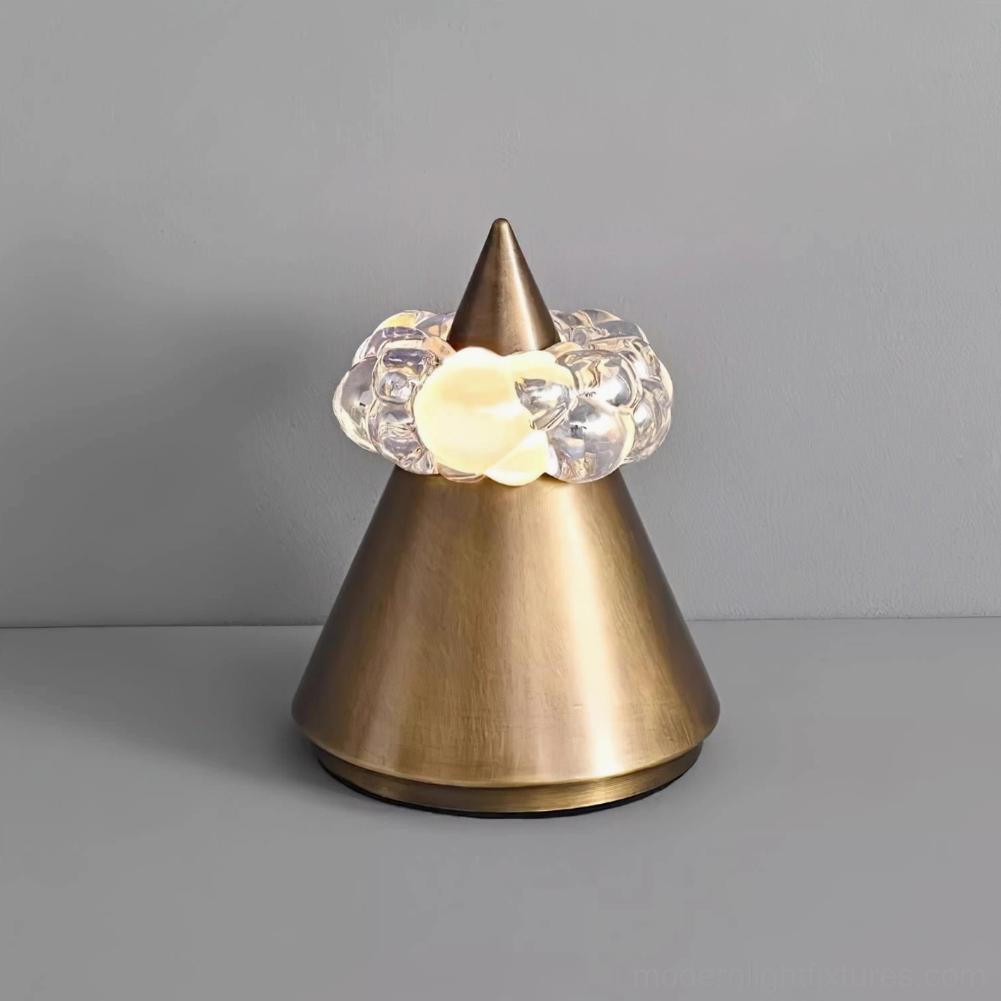 Modern sculptural table lamp showcasing geometric cone design with hand-formed crystal sphere halo and adjustable color temperature LED
