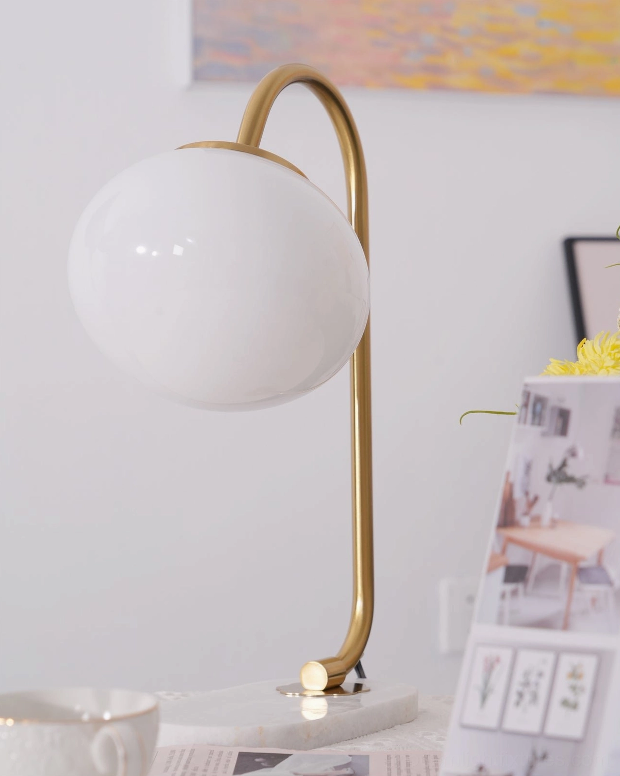 Globe table lamp lighting setup in contemporary living room side table arrangement