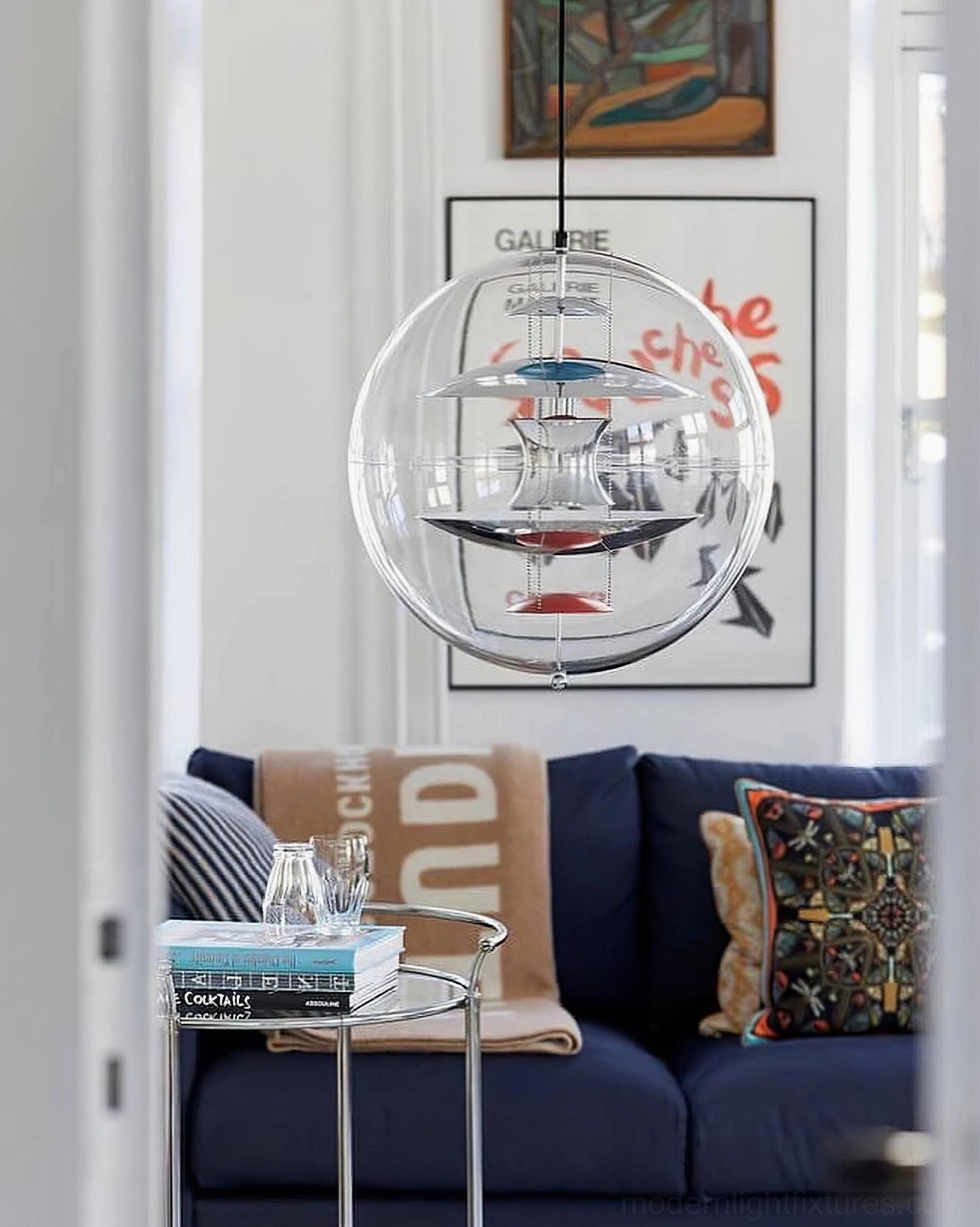 Globe pendant light featuring multi-colored interior reflectors and clear acrylic construction