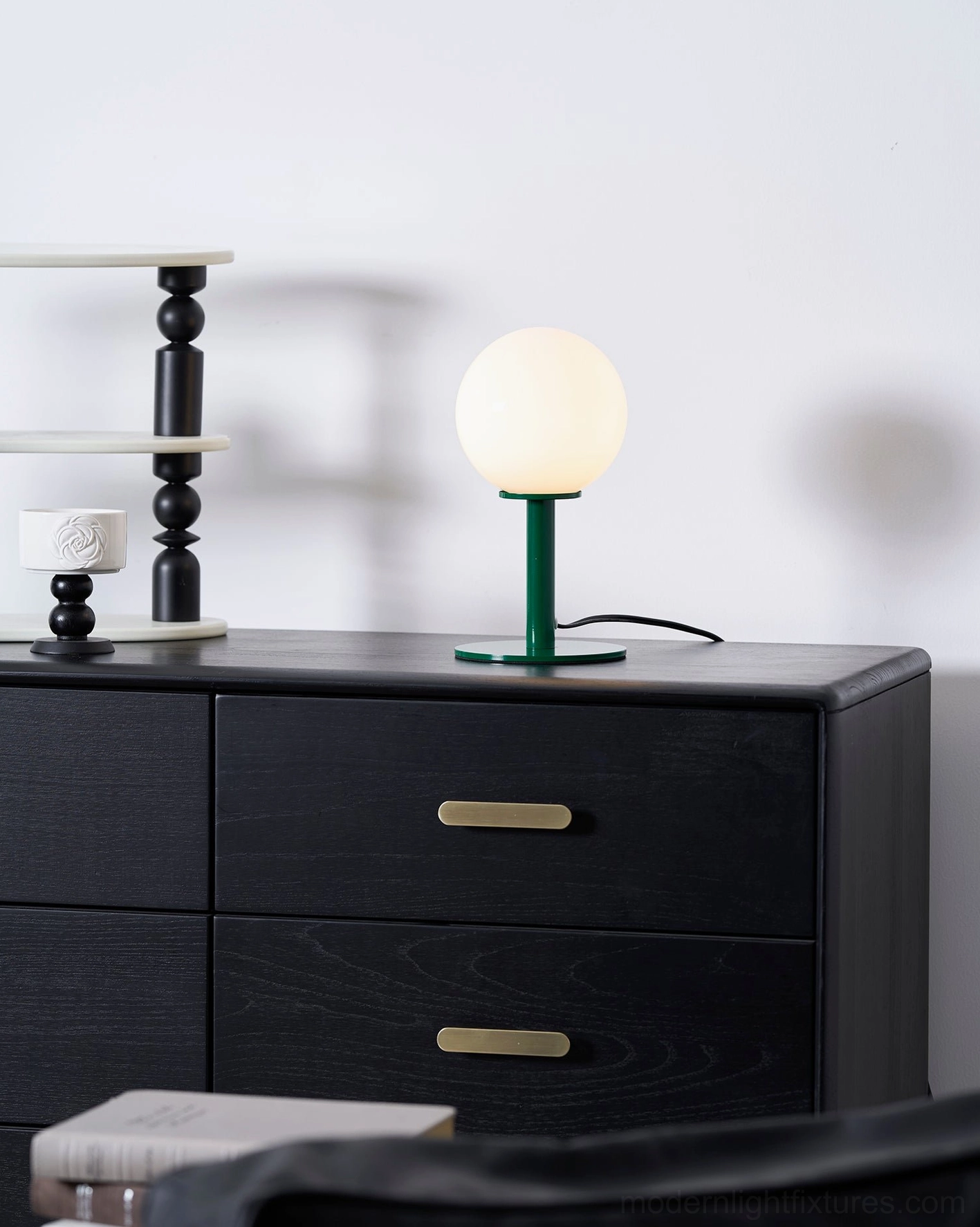 Modern globe table lamp styled with natural decor botanical accents biophilic design aesthetic