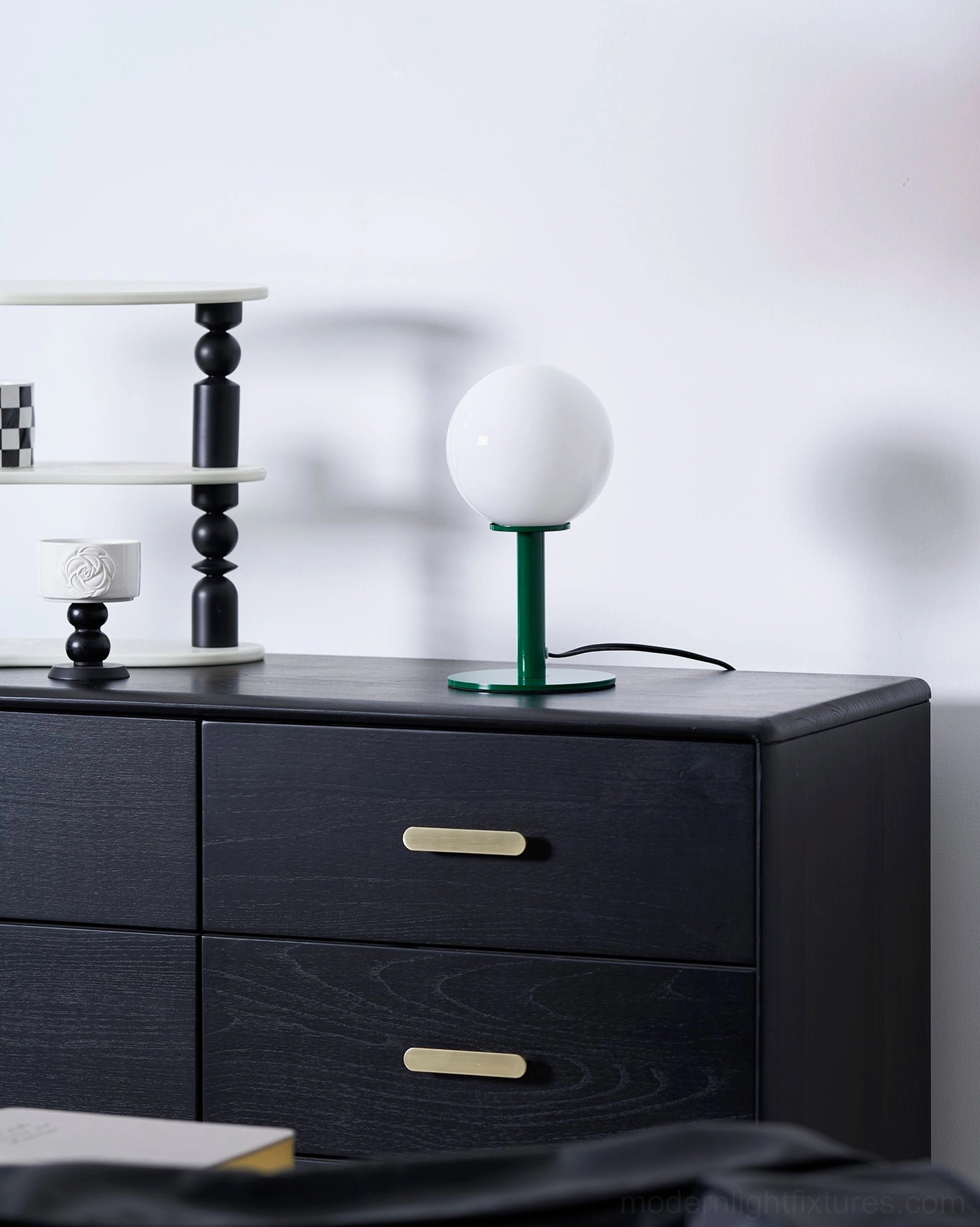 Elegant globe table lamp with glossy finish glass shade and polished metal base interior design