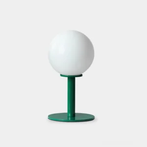 Modern globe table lamp with white glass shade and dark green metal base on white background