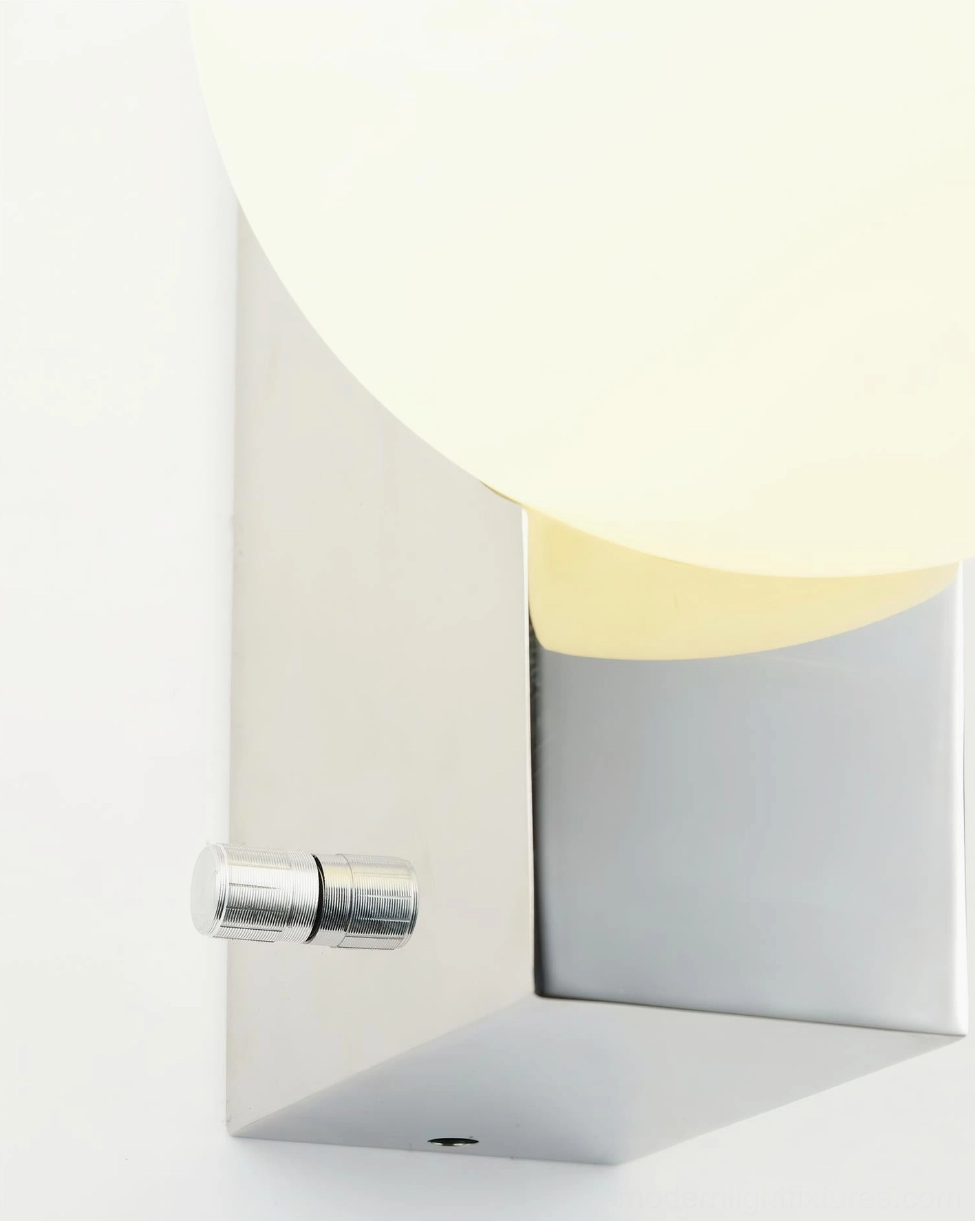 Glowen globe wall sconce with warm frosted glass illuminated, showing soft diffused light and sculptural form