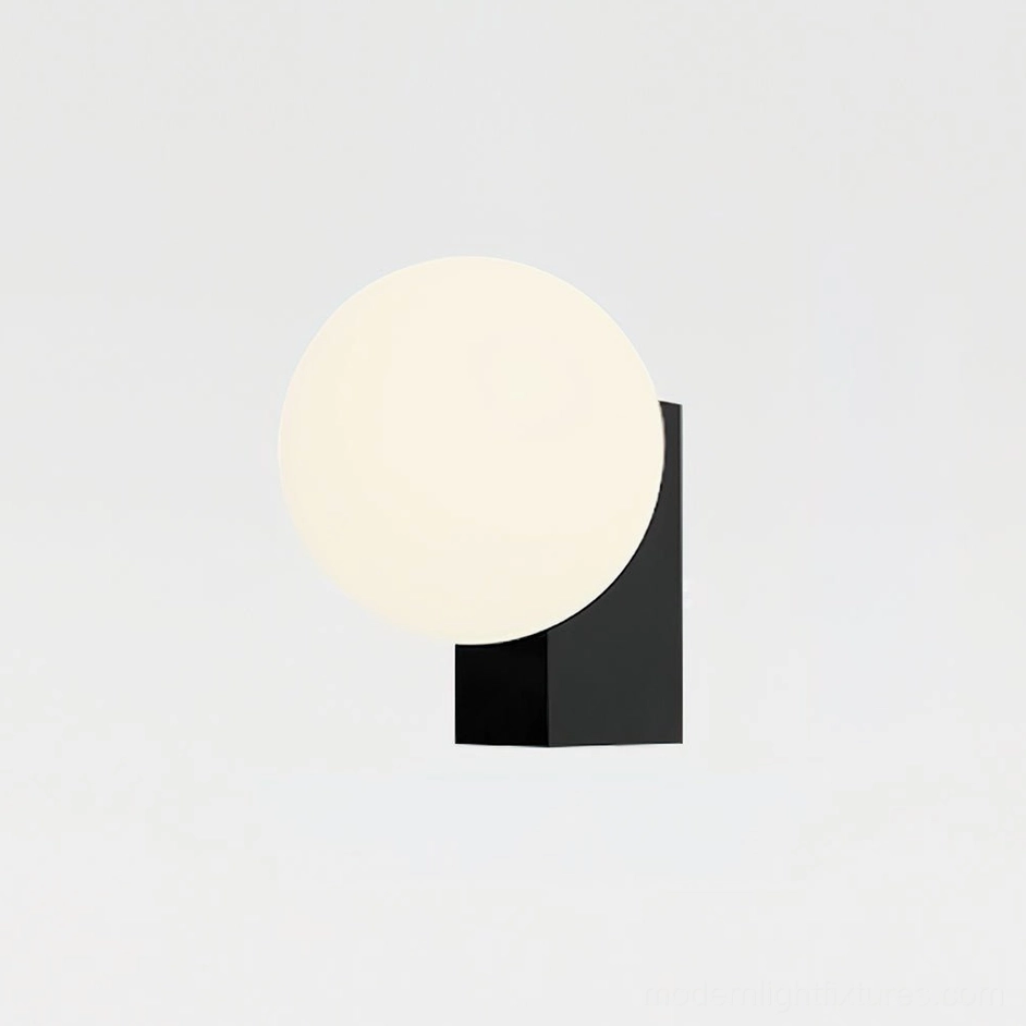 Black and white Glowen globe wall sconce in modern bedroom setting, contemporary wall lamp installation example