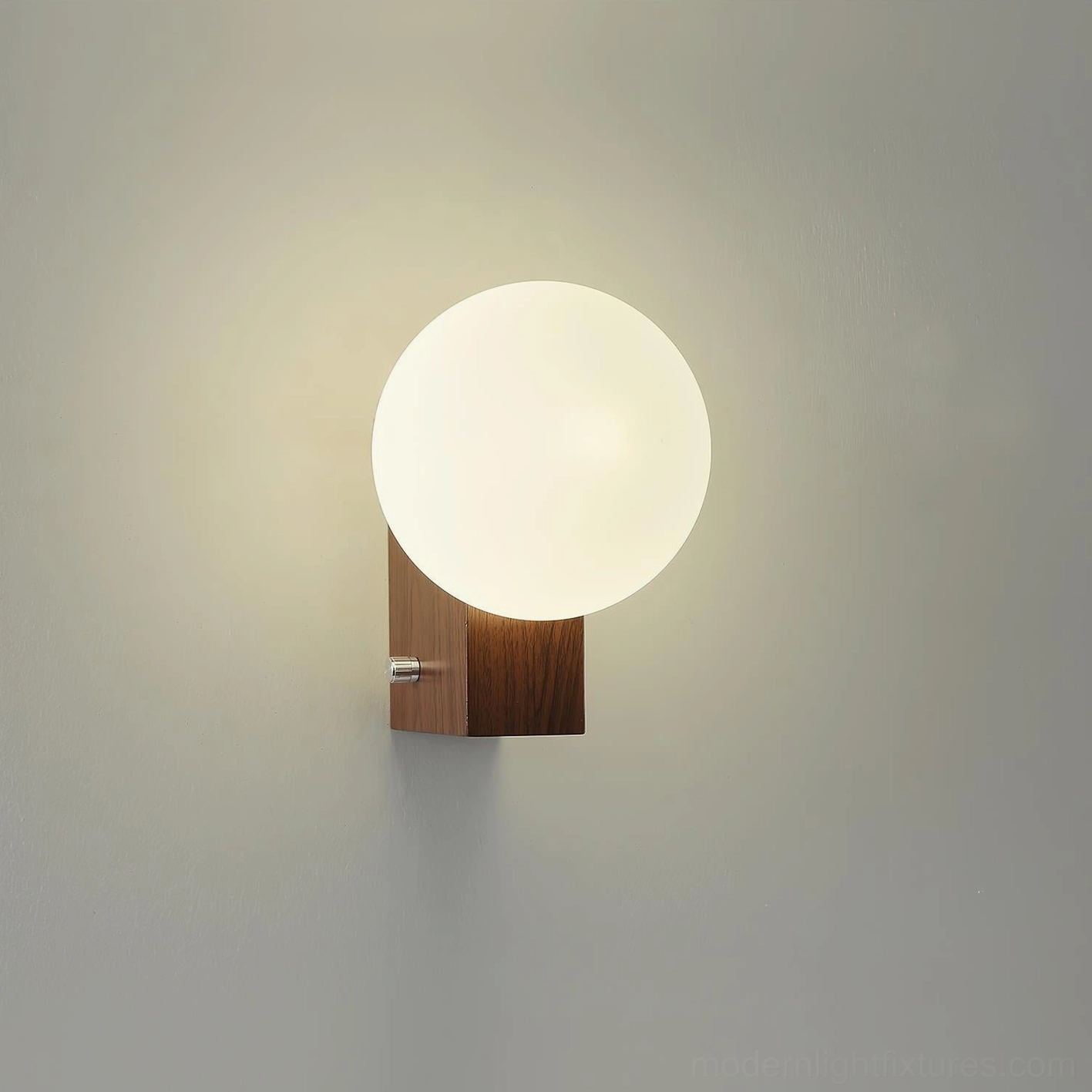 Glowen wall lamp front perspective showing spherical frosted shade and metal hardware, minimalist modern aesthetic