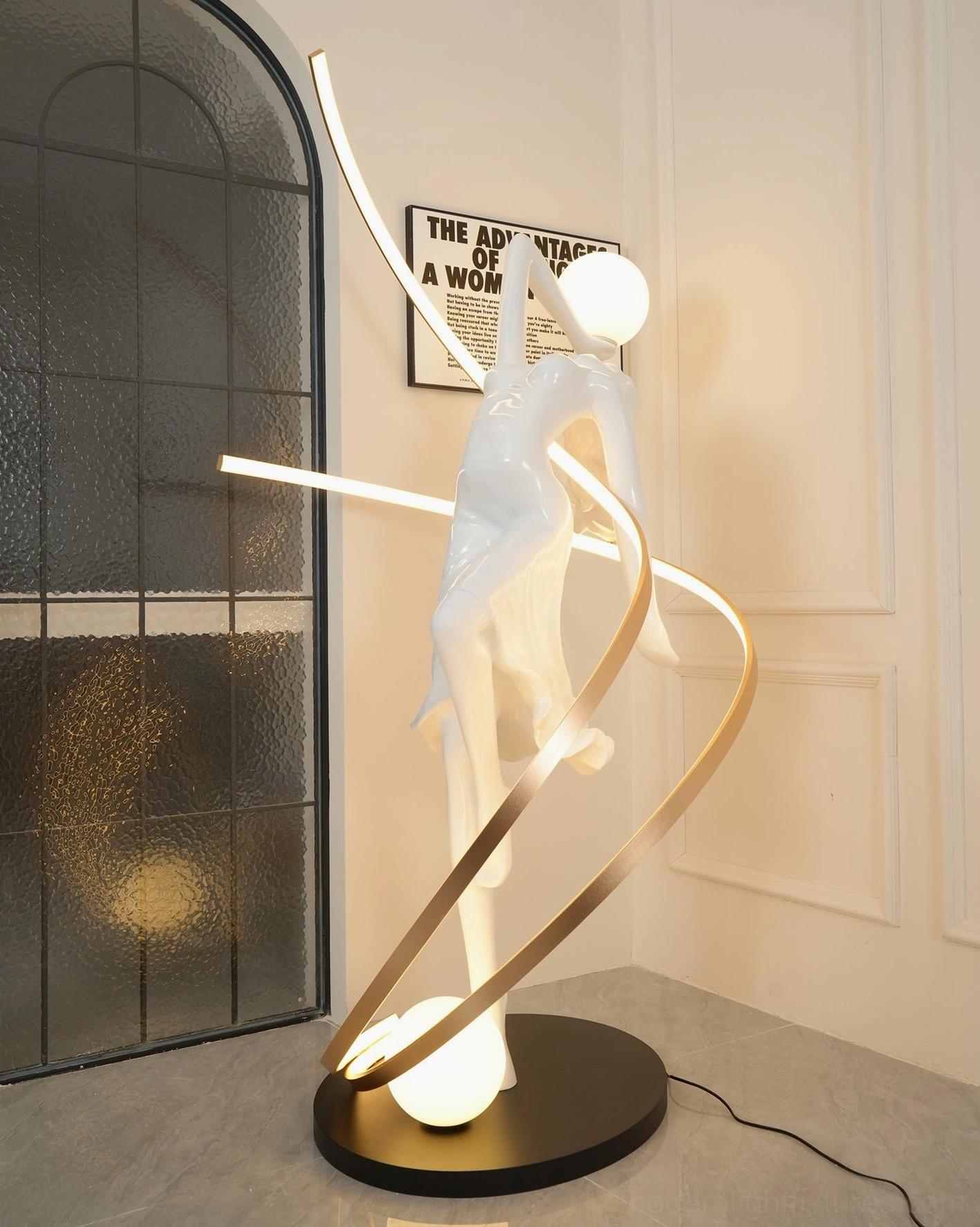 Modern sculptural goddess floor lamp with framed wall art and clean minimalist beige arched window design