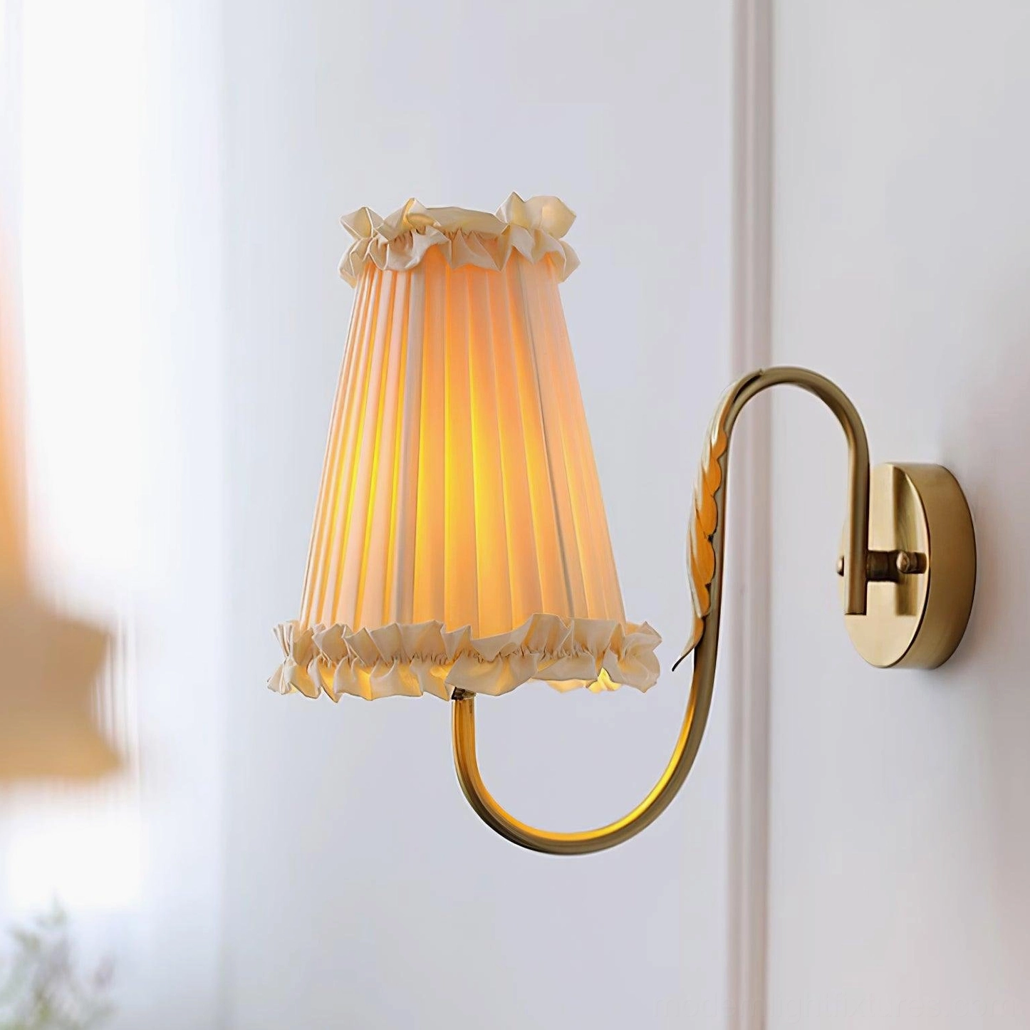 Gold brass wall sconce installed in interior room setting ambiance lighting