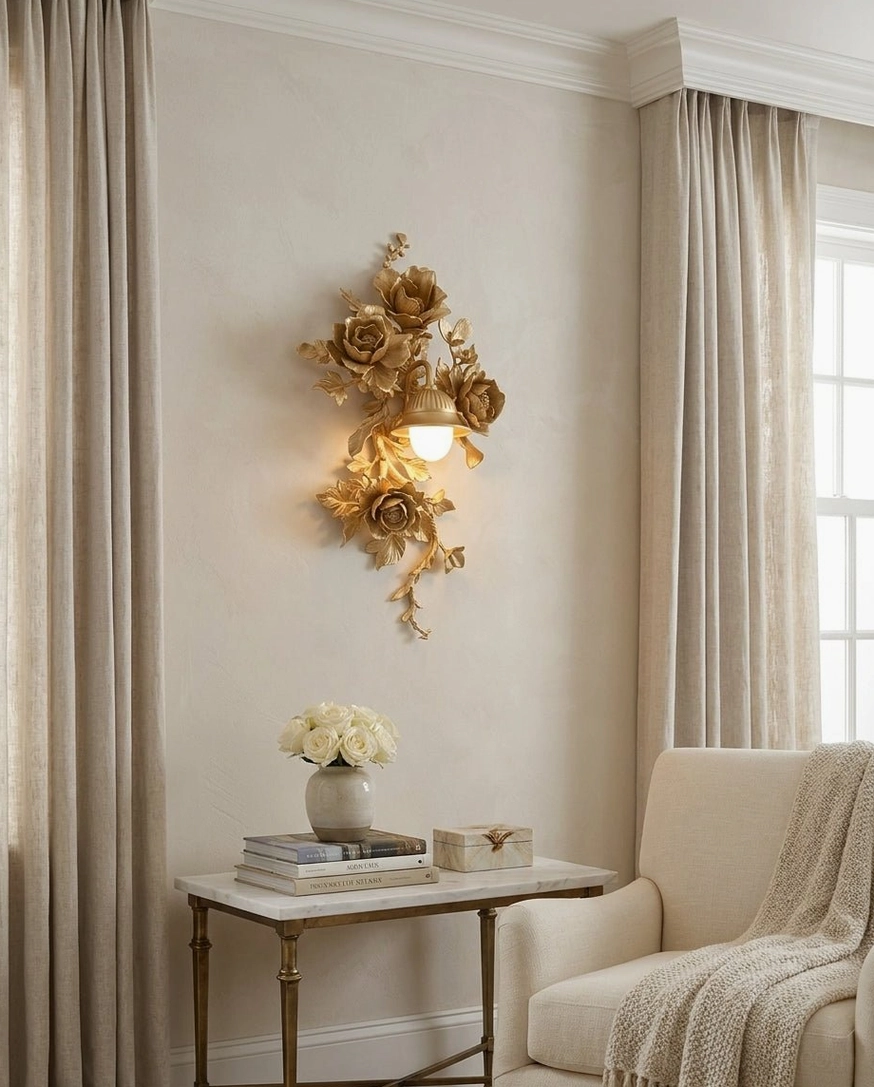 Gold Elysia Bloom hand-carved rose wall sconce in cozy sitting area, warm ambient illumination from downward lantern