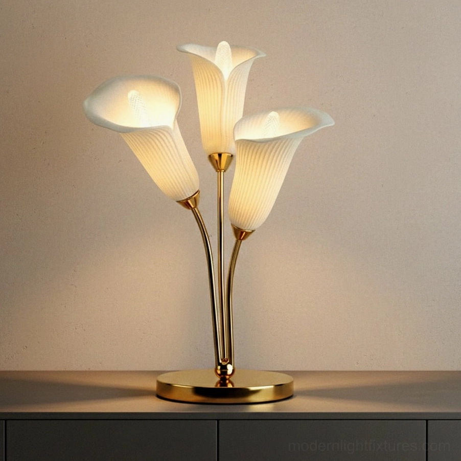 Calla lily table lamp with round gold base and ribbed glass shades on minimalist cabinet top