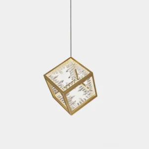 Gold cube pendant light with engraved crystal panels in modern studio setting