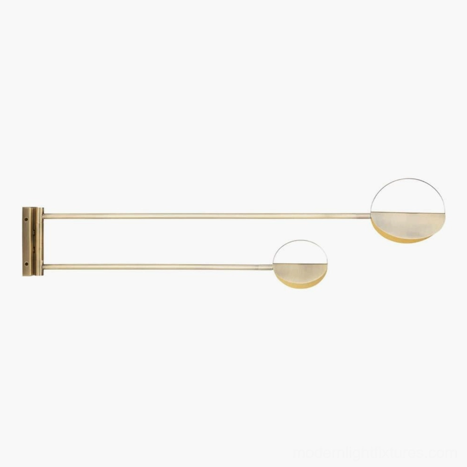 Gold finish modern dual wall sconce with extended metal arms and semi-circular shades in studio flat view