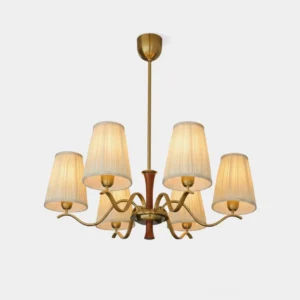 Gold fabric chandelier with pleated beige shades and curved brass arms, front studio view