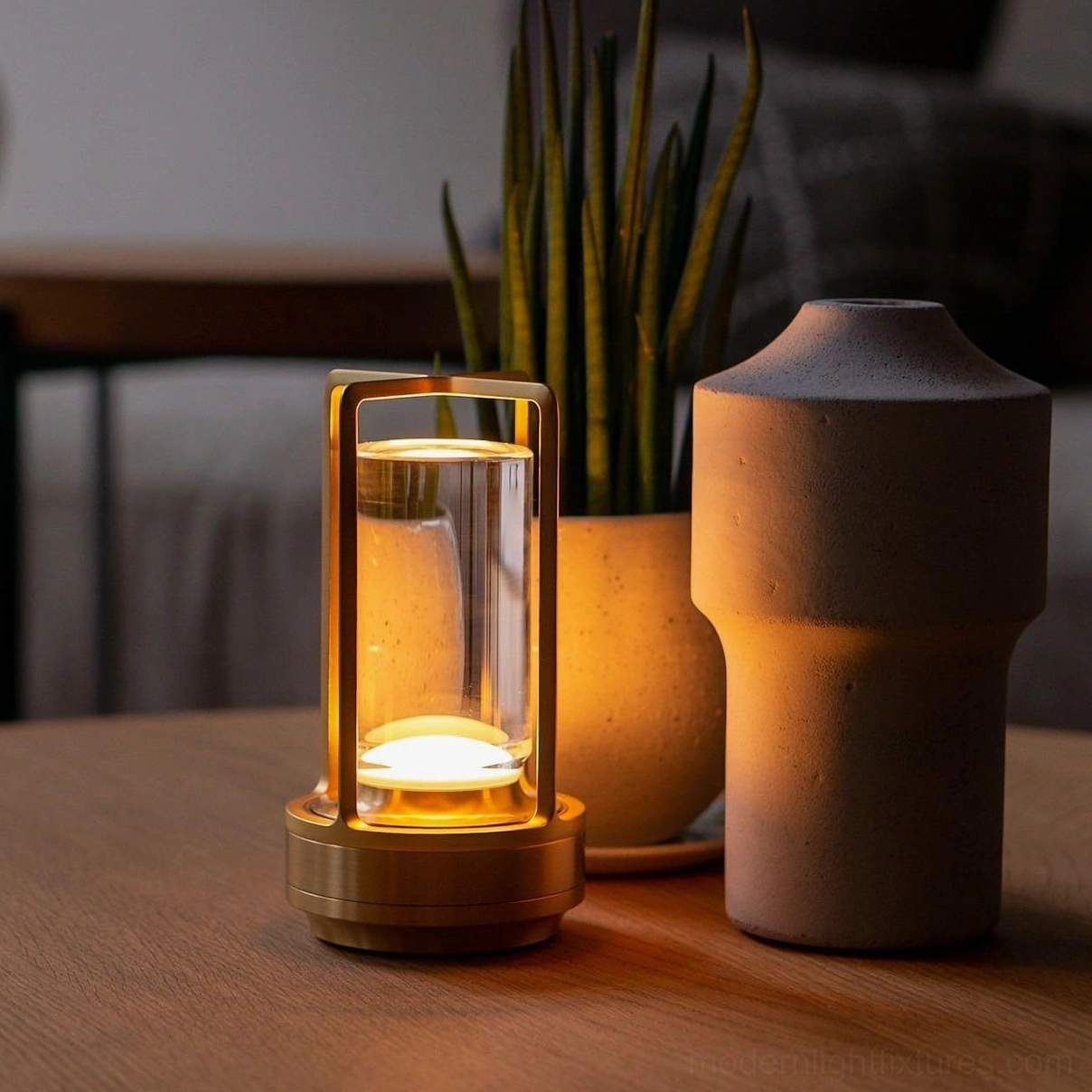 Gold cordless LED table lamp paired with earthy ceramic decor in warm toned home interior, oblique side view