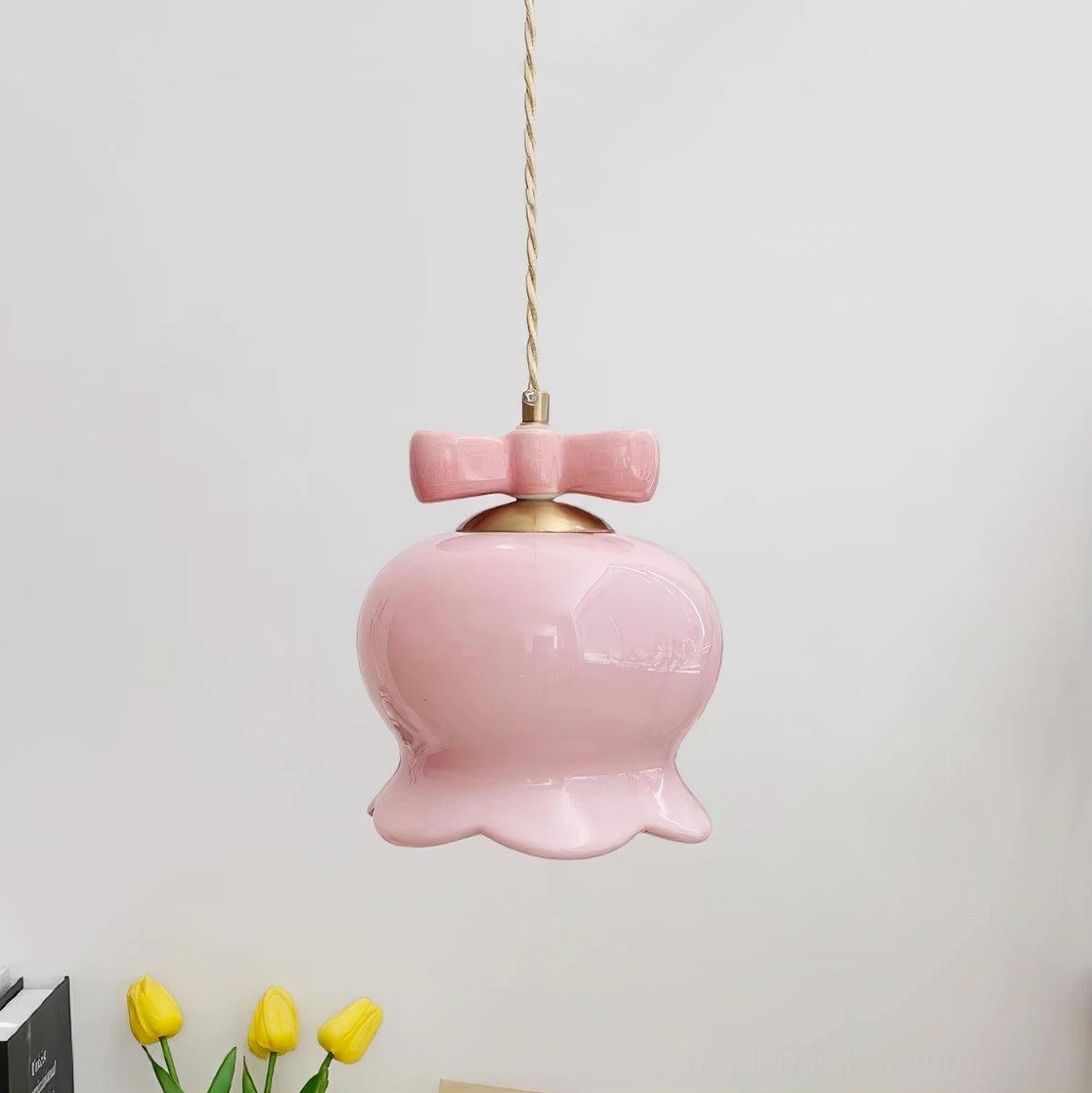 Gold and pink bellflower pendant light showing graceful curved ceramic shade