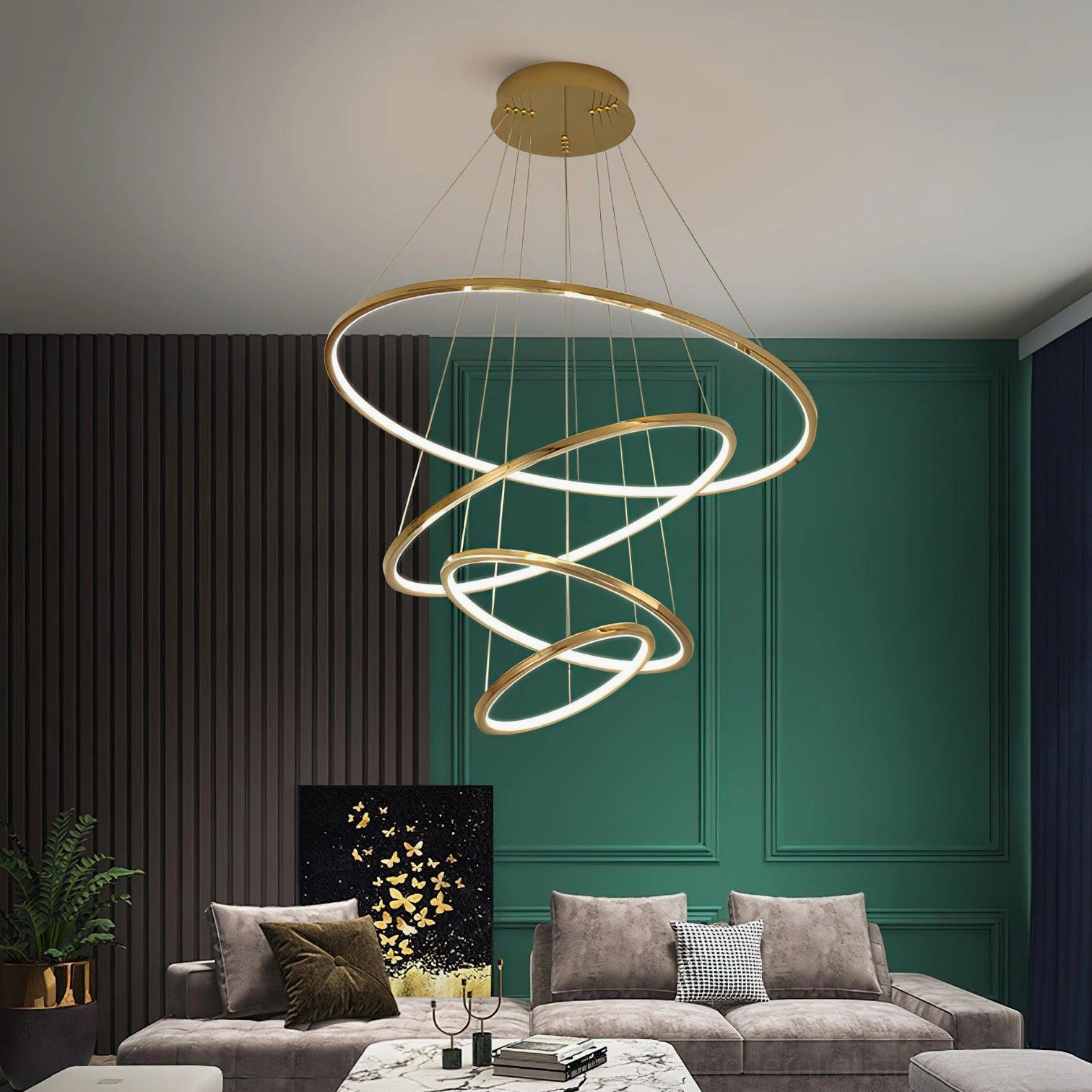 Contemporary gold ring pendant light fixture installed in modern living room with green accent wall