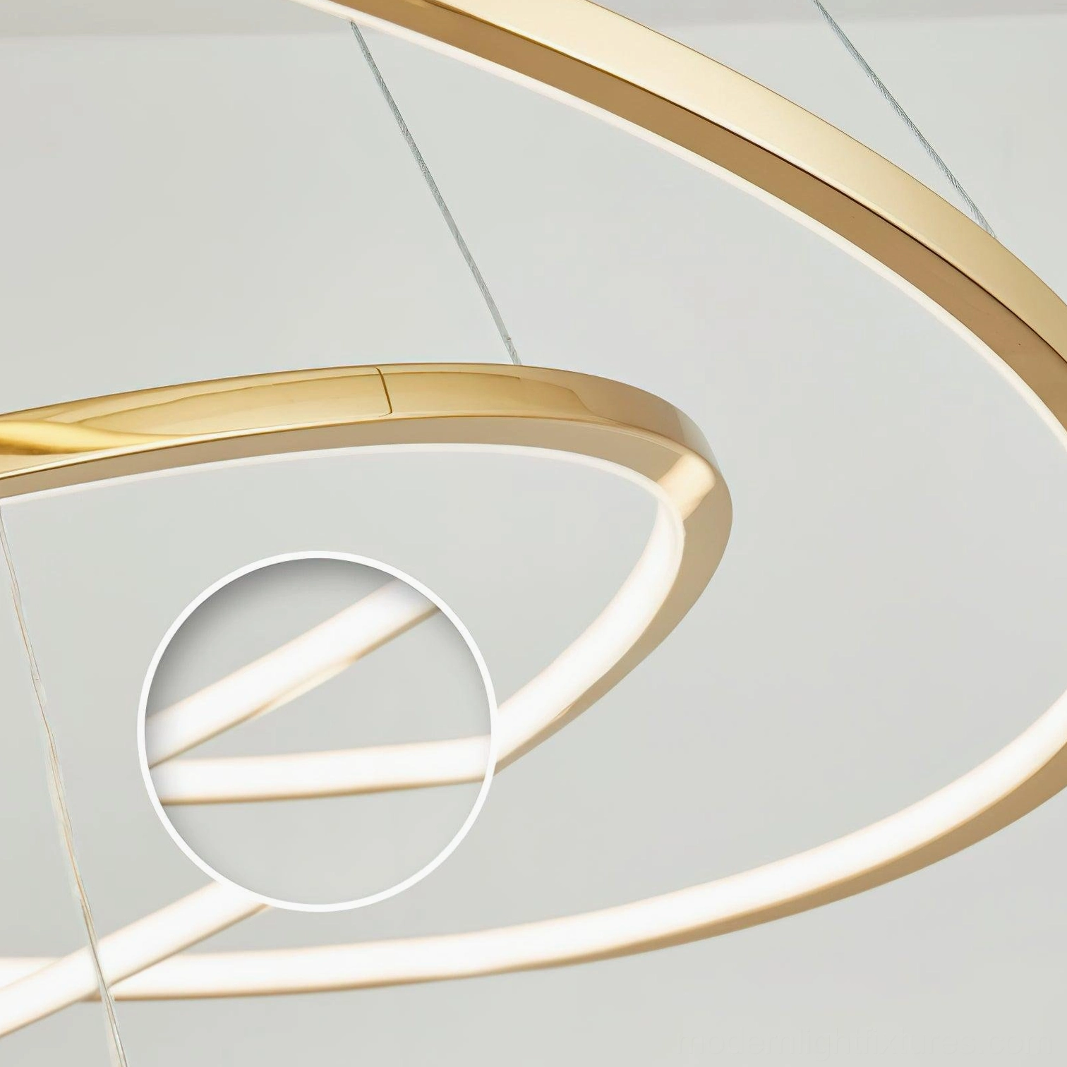Close-up of stainless steel gold ring chandelier illuminated with warm white LED light at 3000K