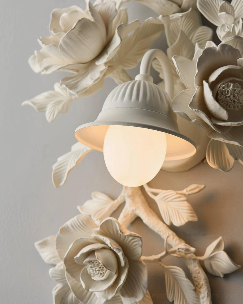 Gold Elysia Bloom rose wall sconce in vintage bedroom setting, sculptural floral accent lighting above furniture